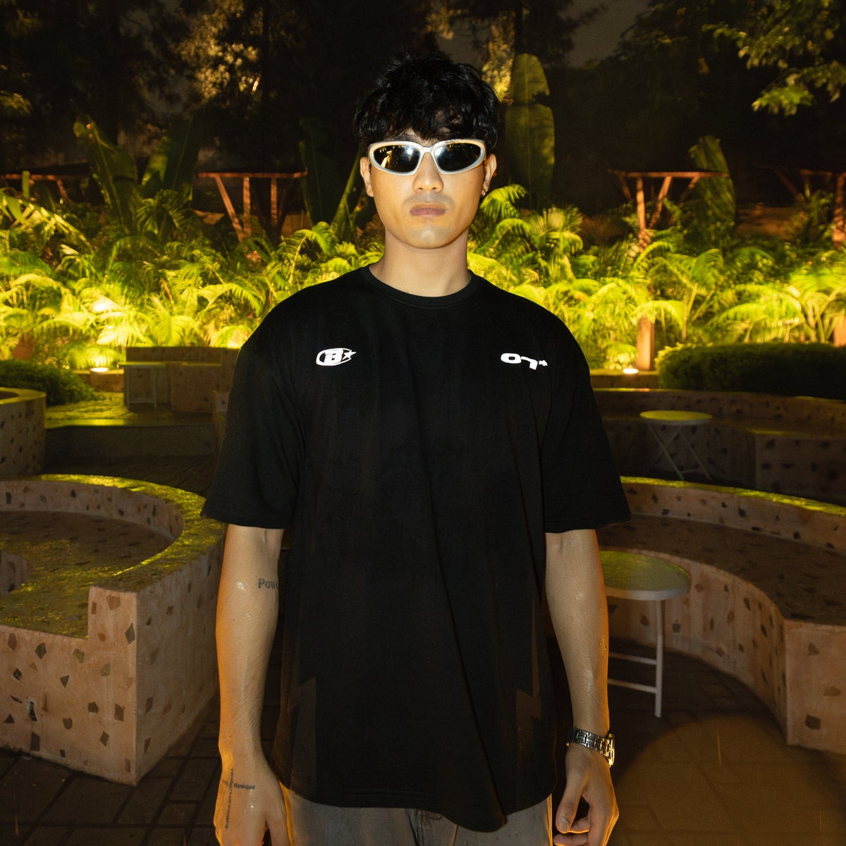 Black short-sleeve jersey T-shirt with small chest logos, crew neck.