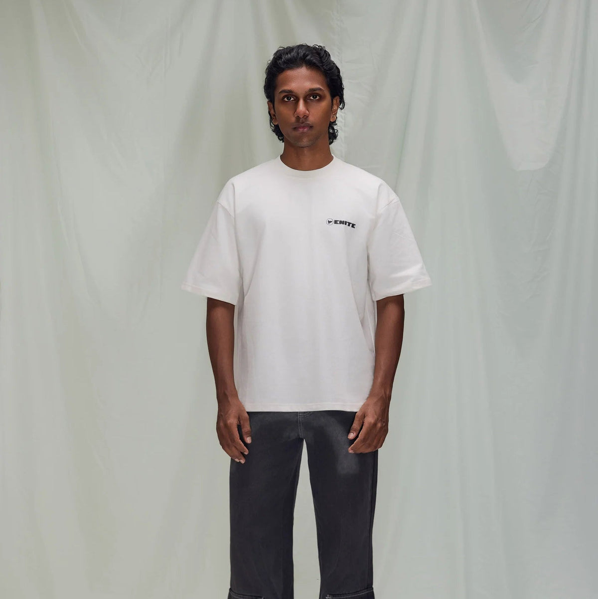 Off-white crew-neck short-sleeve T-shirt with small EMITE logo on chest