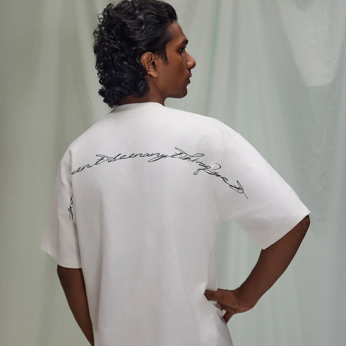 Off-white crew-neck short-sleeve T-shirt with script graphic across back